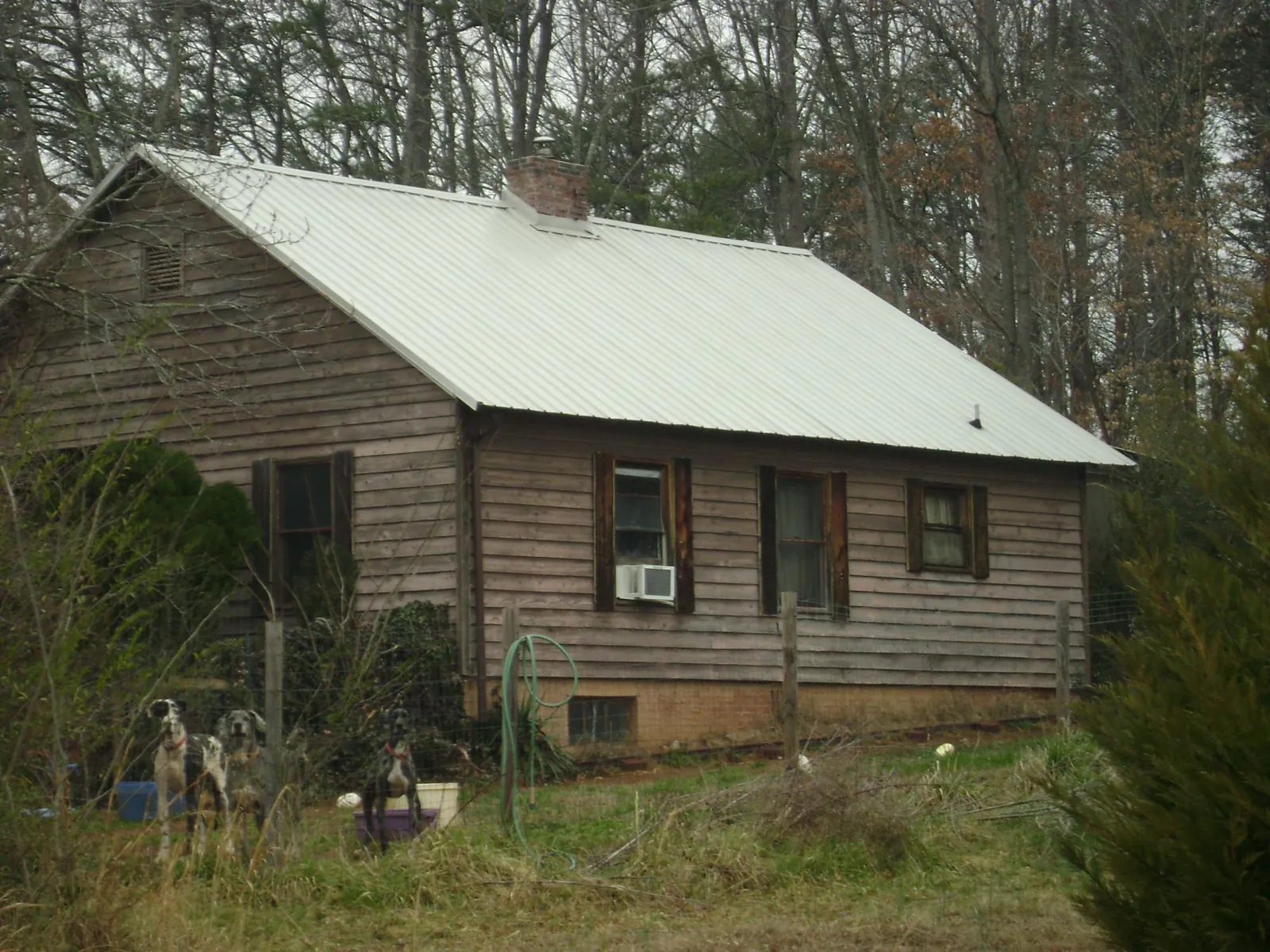 White metal roof on an old wood sided farmhouse, from a Asphalt Shingle Roof Repair job in Doswell